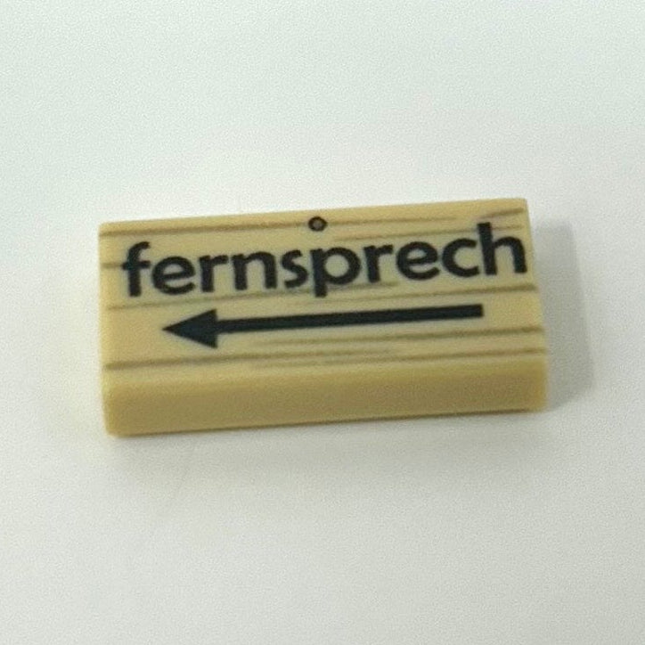 Wooden stamp with 'fern sprech' text on a white background